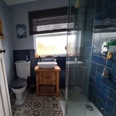 a bathroom with a sink, toilet and shower stall in it's own area