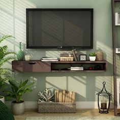 a flat screen tv mounted to the side of a wall next to a shelf filled with books