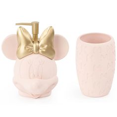 a pink and gold bathroom set with a toothbrush holder, soap dispenser and cup