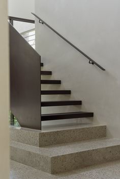 there is a set of stairs leading up to the second floor in this modern house