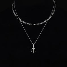 Hey there, meet your new go-to accessory: the Ferni Stainless Steel Trident Pendant & Figaro Chain Necklace Set. It rocks not one, but two chains – one long, featuring the powerful Trident pendant, and the other shorter with a cool Figaro chain design. It's sharp, it's spunky, and it's all about making a statement. This set is packed with meaning, symbolizing self-control and wisdom. Get ready to feel like a hero every time you wear it. Specifications: When it comes to men's necklaces, stainless Metal Chain Link Necklace For Streetwear, Metal Link Necklaces For Streetwear, Streetwear Link Metal Necklaces, Streetwear Metal Link Necklace, Silver Chain Necklaces For Streetwear, Silver Chain Necklace For Streetwear, Streetwear Silver Chain Link Necklace, Metal Cuban Link Necklace For Streetwear, Adjustable Link Chain Necklace For Streetwear