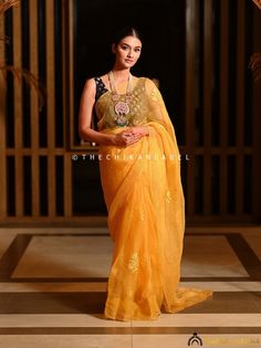 "Yellow Chikankari Saree in Organza Fabric for Women Hand Embroidered Lucknowi Chikan Sari for Wedding Bollywood Wear Sari Blouse for Her > Saree Fabric: Organza > Saree Length: 5.9 Mtrs. > Blouse Fabric: Organza > Blouse Length: 0.80 Mtrs. > Occasions: Party Wear, Wedding Wear, Festive Wear > Price Includes: Saree with an Un-stitched Blouse Thechikanlabel designer studio presents \"Yellow Chikankari Saree in Organza Fabric for Women\" Floral motifs with 'intricate embroidery' are delicately placed on this handmade Chikankari Saree, this perky hand embroidered Lucknowi Chikan Sari is a reminiscent of blooming springs and the serenity that surrounds it. Your skin will surely fall in love with soft fabric that will keep you comfortable all day long and make yourself happier this season by ch Anarkali Chikankari Pre-draped Tussar Silk Saree, Ceremonial Pre-draped Saree With Cutdana For Transitional Season, Navratri Pre-draped Chikankari Saree In Tissue Silk, Navratri Pre-draped Saree With Chikankari Embroidery, Organza Pre-draped Saree With Chikankari Embroidery For Navratri, Festive Designer Pre-draped Saree With Chikankari Embroidery, Navratri Organza Pre-draped Saree With Chikankari Embroidery, Navratri Organza Saree With Chikankari Embroidery, Yellow Pre-draped Saree With Resham Embroidery For Transitional Seasons