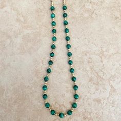 Stunning malachite beads necklace adorned with gold beads and finished off with a sparkly cz clasp can absolutely be used as a charm holder. Length 16" Malachite, with its pure green ray is a "growth crystal" a powerful conduit of the earth’s life force of birth, development, and creation, and of the power of nature’s constant renewal. It is a potent aid in nurturing, whether of fledgling family relationships or a new business venture. -This information is intended for spiritual support only- Be Malachite Gemstone Bead Necklaces, Malachite Gemstone Beads Necklace, Turquoise Malachite Necklaces With Round Beads, Beaded Green Onyx Round Beads Necklace, Green Onyx Beaded Necklaces, Green Onyx Beaded Round Necklaces, Gold Emerald Necklaces With Gemstone Beads, Spiritual Malachite Beaded Jewelry, Malachite Beaded Necklace As Gift