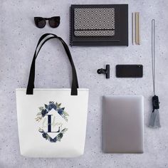 Our Personalized Blue Floral Initial Name Tote Bag makes a great gift for a friend, family member, coworker, bridesmaid or even a gift to yourself. This practical, high-quality Tote Bag is available in three sizes. All over print provides comfort with style at the beach or out in town. Made from reliable materials, lasting for seasons. Features: - 100% Polyester - Boxed corners - Black cotton handles - Black lining Care Instructions: Before cleaning the bag, remove all the items from bag. Sugges Patriotic Pillow, Flowers Tote Bag, Flowers Tote, Floral Initial, Initial Name, Floral Monogram, Family Christmas Shirts, Christmas Tees, Bridesmaid Gift