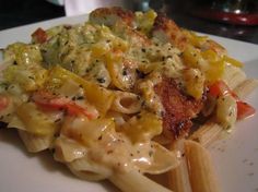 pasta with chicken and vegetables on a white plate