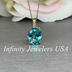 "This is a Paraiba Tourmaline Pendant Necklace,It is Made in 14K Gold, This Is a Paraiba and Diamond Pendant Necklace, It is a Dainty Necklace For Ladies, This is a Lab Created Paraiba tourmaline, #6289 This necklace is an oval lab created neon blue paraiba with diamond, 14k yellow gold #6289 -Approximate total carat weight: 4.25ctw diamond equivalent -Center Stone Size: approx. 4.20ct diamond equivalent -Center Stone Shape: oval 11x9mm -Gem Type: lab created paraiba -Stone Clarity: VS2 -Stone C Paraiba Tourmaline Engagement Ring, Paraiba Tourmaline Ring, Pink Sapphire Pendant, Tourmaline Engagement Ring, Emerald Wedding Rings, Oval Necklace, Paraiba Tourmaline, Tourmaline Pendant, Tourmaline Necklace