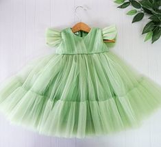 "Apple green tulle dress for baby girls and toddlers! Perfect for formal events, as flower dress, birthday party, wedding and fairy photo shoot. The dress is made of soft tulle. Little fluffy butterfly sleeves are added to complete the whole look. The bodice is decorated with elegant tulle draping. We make dresses in standard sizes and by individual measurements. If your measurements differ from those below please send us your measurements in order note. The dress will come in the same color you Fairy Photo Shoot, Tulle Draping, Green Tulle Dress, Green Wedding Dress, Flower Girl Dress Tulle, Flower Girl Outfits, Blue Tulle Dress, Outfits Pastel, Frocks For Kids