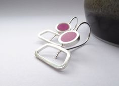 These abstract wide drop earrings are handmade in recycled Sterling Silver and magenta pink resin. The neat shape and curves are inspired by mid-century British sculpture and are a very wearble pair of earrings. > 3 x 1.5 cm > Sterling Silver and resin > Made to order > Handmade in Bath, England > Posted by registered mail, where available I hand make each pair from square profile Sterling Silver, adding a curvy, secure Sterling ear wire. The crisp square edge frames a pop of colour in lightweig Blue Statement Earrings, 3d Printed Earrings, Pink Rectangle, Large Stud Earrings, Bath England, Minimalist Earrings Studs, Lapis Lazuli Earrings, Polyester Resin, Minimalist Studs