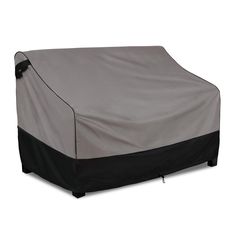 an outdoor furniture cover with black and gray trimmings on the top, in front of a white background