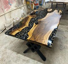 a table made out of wood with black and white designs on it in a workshop