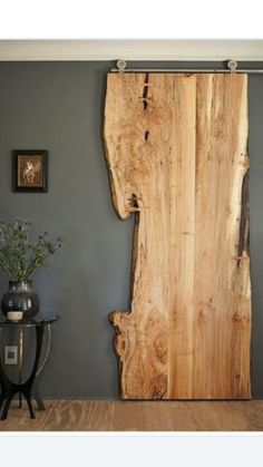 a large piece of wood sitting on top of a wooden floor next to a table