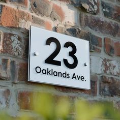 a sign on the side of a brick building that says 23 oakland ave