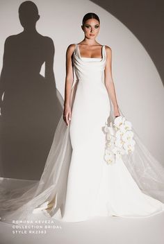 a woman in a white wedding dress holding a bouquet