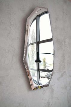 a mirror hanging on the side of a wall