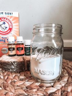 a mason jar sitting on top of a table next to some bottles and an orange box