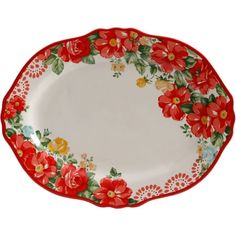 a red and white plate with flowers painted on the side, sitting in front of a white background