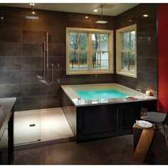 a bathroom with a large jacuzzi tub next to a window