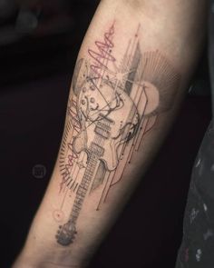 a person with a guitar tattoo on their arm