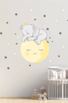 an elephant is sleeping on the moon wall decal in a child's room