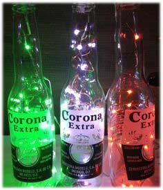 three bottles with lights in them sitting on a table