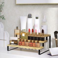 there are many different types of cosmetics on the shelf in front of each other,