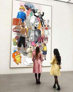 two girls looking at an art work on display in a museum gallery, one is wearing a yellow dress and the other has a pink coat