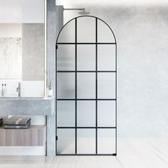 a white bathroom with a glass shower door