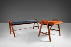 two wooden benches with upholstered seats and one bench has a seat cushion on it