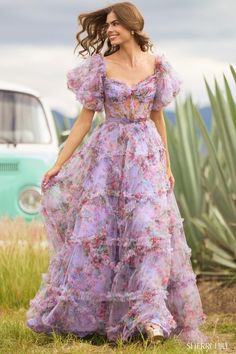 Sherri Hill 55541 Tulle floral print gown with sheer corset bodice, ruffle embellishments and ballon sleeves. Floral Print Gowns, Dress Shops, Chic Jumpsuit, Floral Prom Dresses, Sherri Hill Prom Dresses, Prom Dress Stores, Printed Gowns, Prom Dress Styles, Floral Gown