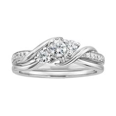 a white gold ring with two diamonds on top and the center diamond in the middle