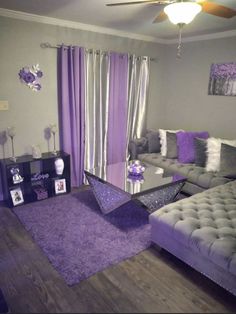 a living room filled with furniture and purple accents