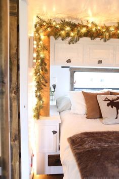 a bed with christmas lights on the headboard