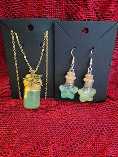 Add a touch of enchantment to your style with this charming Magic Shimmer Potion Bottle Necklace and Earring Set! This whimsical pendant features a miniature glass bottle filled with sparkling shimmer potion, capturing the essence of magic and mystery. The glass bottle is securely sealed and suspended from a dainty chain, perfect for adding a hint of mystical allure to any outfit. Whether you're a lover of fantasy or simply appreciate unique jewelry, this set is sure to bring a touch of magic to your day. Perfect for cosplay or ren faire accesories! ONE OF A KIND PIECE PLEASE NOTE I MAY NOT BE ABLE TO RECREATE THIS SPECIFIC COLOR! (If You Love it.. Get it now!) ;) Each necklace set is a handmade treasure and  truly ONE OF A KIND!  Chains (22.5" long) with easy to use clasps. 925 Sterling S Witch Potion Necklace, Handmade Magical Style Green Jewelry, Handmade Magical Green Jewelry, Mystical Green Jewelry For Gift, Fantasy Dangle Jewelry Gift, Mystical Green Jewelry As Gift, Shimmer Potion, Color Changing Potion, Potion Bottle Necklace