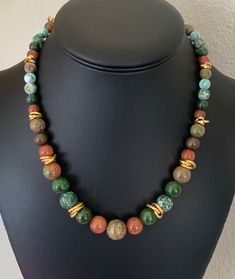 This mixed jasper and gold stone and faux stone choker necklace is 21 inches long with a lobster claw clasp and adjustable chain.  The necklace has great earthy colors and bright shiny gold.  It is a great way to add color to an outfit. I specialize in finding high quality vintage costume jewelry.  Please browse my shop for more options.  I box jewelry sales in new gift boxes. I often combine multiple item purchases to save on shipping. Please message me if you wish to combine 3 or more items. Unique Gold Rings, Bead Choker Necklace, Stone Choker, Bead Choker, Beaded Choker Necklace, Gold Stone, Faux Stone, Box Jewelry, Jasper Stone