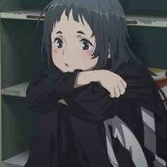 an anime character with long black hair standing in front of a book shelf and looking at the camera