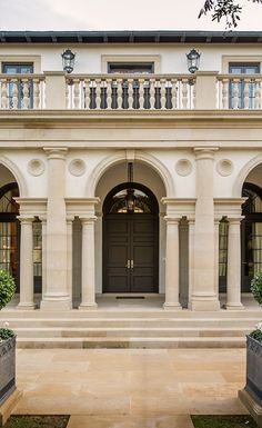 a large white building with two planters in front of it