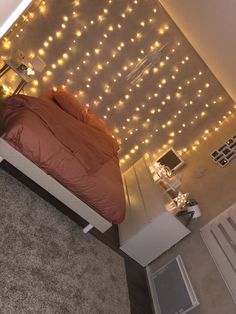 a bedroom with lights on the wall and a bed in it's center area