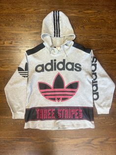 Rare Vintage 90s Adidas Trefoil Big Logo Three Stripes Hoodie & Jogger Set Step back into the golden era of streetwear with this rare vintage Adidas hoodie and jogger set from the 90s. Featuring the iconic Adidas Trefoil logo in bold, oversized print and the signature three-stripes running down the sleeves and legs, this matching set is a must-have for true collectors and vintage fashion enthusiasts alike. Crafted from soft, comfortable fabric, the hoodie offers a relaxed fit with an adjustable drawstring hood and ribbed cuffs, while the joggers feature an elastic waistband and cuffed ankles for ultimate comfort and retro style. Perfect for lounging, working out, or hitting the streets in style, this classic tracksuit set embodies the essence of 90s Adidas fashion. Details: *Authentic vint Adidas 2000 Vintage, Jogging Adidas, Hoodie Jogger Set, Adidas Set, Retro Sportswear, 90s Adidas, Adidas Three Stripes, Adidas Tracksuit, Cuffed Joggers