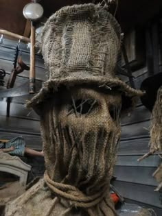 a creepy looking scarecrow wearing a hat