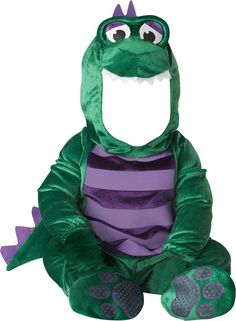 a green and purple alligator costume sitting on the ground