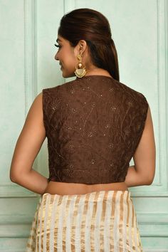 Brown chanderi padded blouse with thread, floral embroidery.
Component: 1
Pattern: Embroidery
Type Of Work: Thread, floral
Neckline: V neck
Sleeve Type: Sleeveless
Fabric: Chanderi, Lining: Cotton Silk
Color: Brown
Other Details: 
Note: Saree worn by the model is not for sale
Occasion: Puja - Aza Fashions Women Saree, Padded Blouse, Saree Blouses, Pattern Embroidery, Blouse For Women, Blouse Online, V Neck Blouse, Embroidered Blouse, Saree Blouse