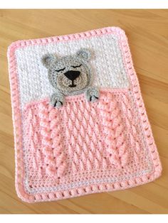 a crocheted blanket with a teddy bear on it