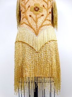 "This is an EXQUISITE heavily embellished vintage dress! It's completely hand beaded with glass beading and in excellent condition! Bust - 34-38\" Waist - 26-30\" Hips - 35-39\" Dress Length - 34\" / 38\" to the bottom of the fringe This dress comes from a pet-free and smoke-free home. If you would like more info or have any questions, please don't hesitate to ask!" Fitted Couture Dresses For Festive Season, Festive Couture Embellished Dresses, Festive Embellished Couture Dresses, Fitted Embellished Flapper Dress For Festive Occasions, Festive Fitted Embellished Flapper Dress, Festive Embellished Fitted Flapper Dress, Glamorous Fitted Dress With Intricate Embroidery, Fitted Beaded Fringe Flapper Dress For Gala, Beaded Fringe Fitted Flapper Dress For Wedding