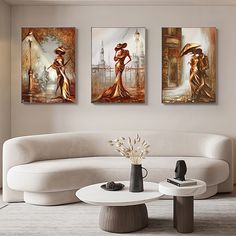 a living room with three paintings on the wall