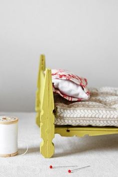 a sewing machine next to a yellow bed