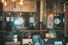 two people sitting at a table in a restaurant