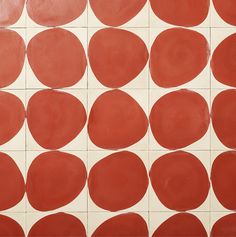 a red and white tiled wall with circles on it