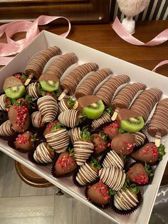 a box filled with chocolate covered strawberries and kiwis