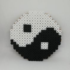 a black and white skull made out of perler beads