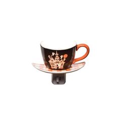 an orange and black coffee cup on a saucer